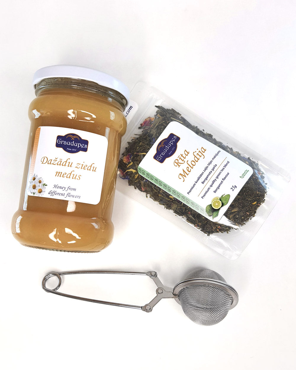 The "Tea Gift Set with Honey"  a 25g tea blend, a metal tea mesh strainer, and a 400g jar of honey | Graudupes