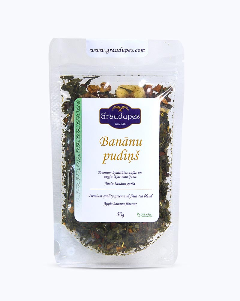 Packed tea in transparent doypack, front side. Banana Pudding, Graudupes Whole Leaf Green Tea Blend, Sencha Loose Leaf Tea with dried Apple and Banana Pieces.