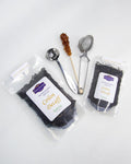 Packed tea with accessories: stainless steel tea mesh strainer, tea spoon measurement, sugar crystal stick. Ceylon Decaff, Graudupes decaffeinated black tea, whole leaf black tea Ceylon.