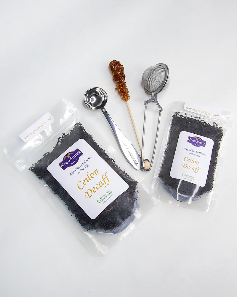 Packed tea with accessories: stainless steel tea mesh strainer, tea spoon measurement, sugar crystal stick. Ceylon Decaff, Graudupes decaffeinated black tea, whole leaf black tea Ceylon.
