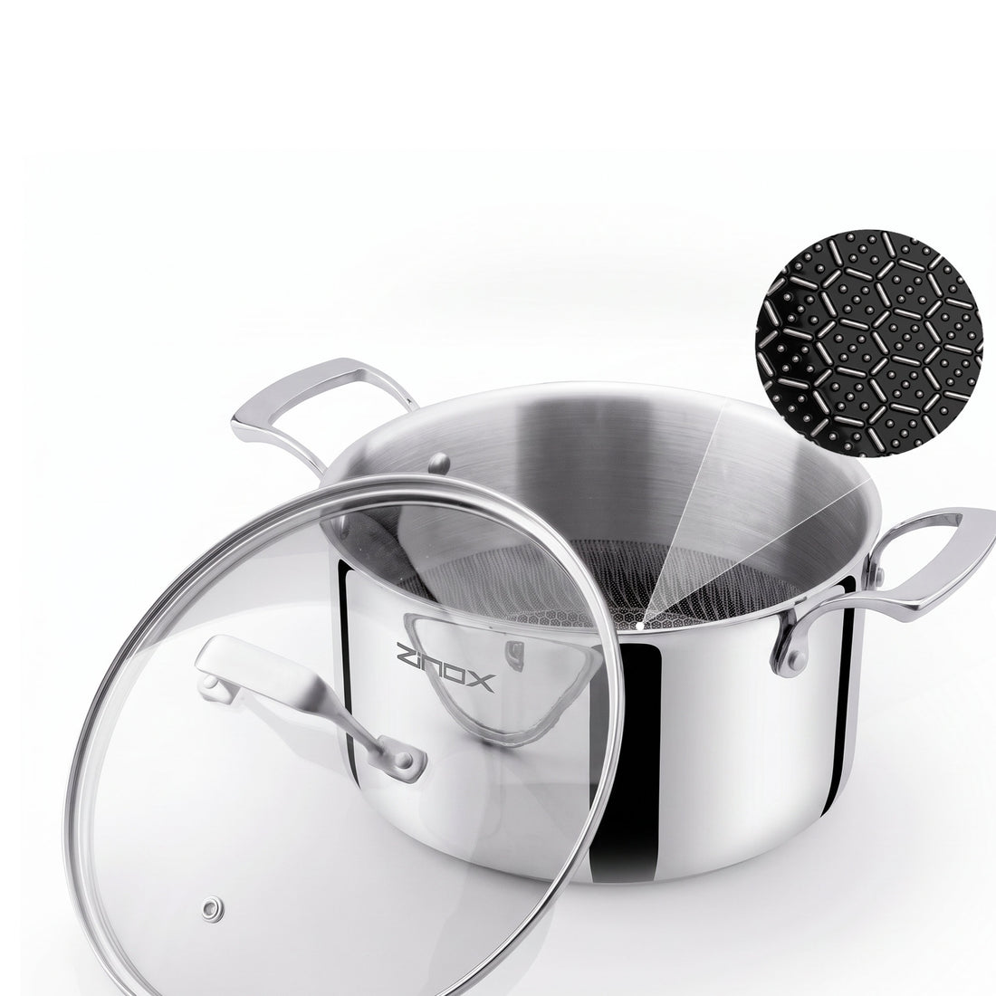 A stainless steel stockpot with a clear glass lid, shown on a white background with a black ceramic coating in a hexagon shape inside, and a small ZINOX logo on the pot.