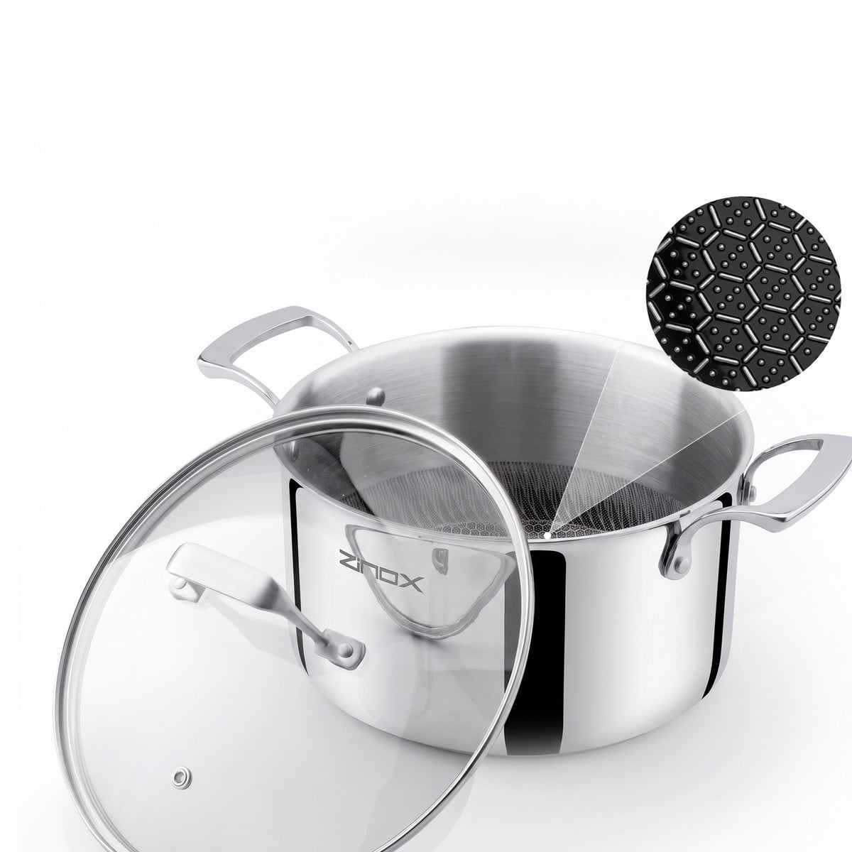 A stainless steel stockpot with a clear glass lid, shown on a white background with a black ceramic coating in a hexagon shape inside, and a small ZINOX logo on the pot.